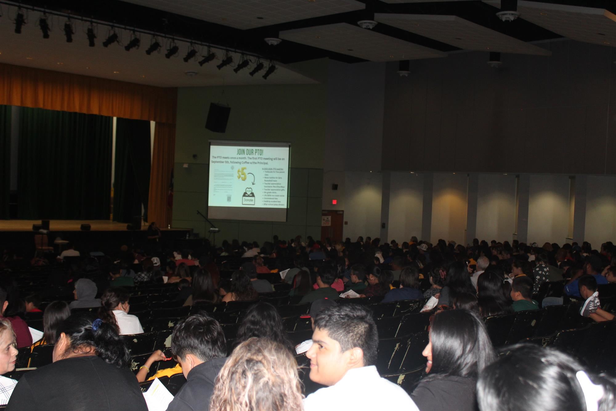 Parents in the auditorium for the meet the teacher